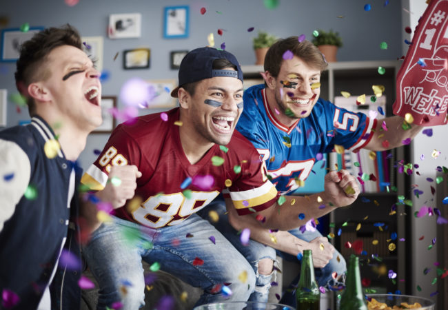 American football fans among falling confetti